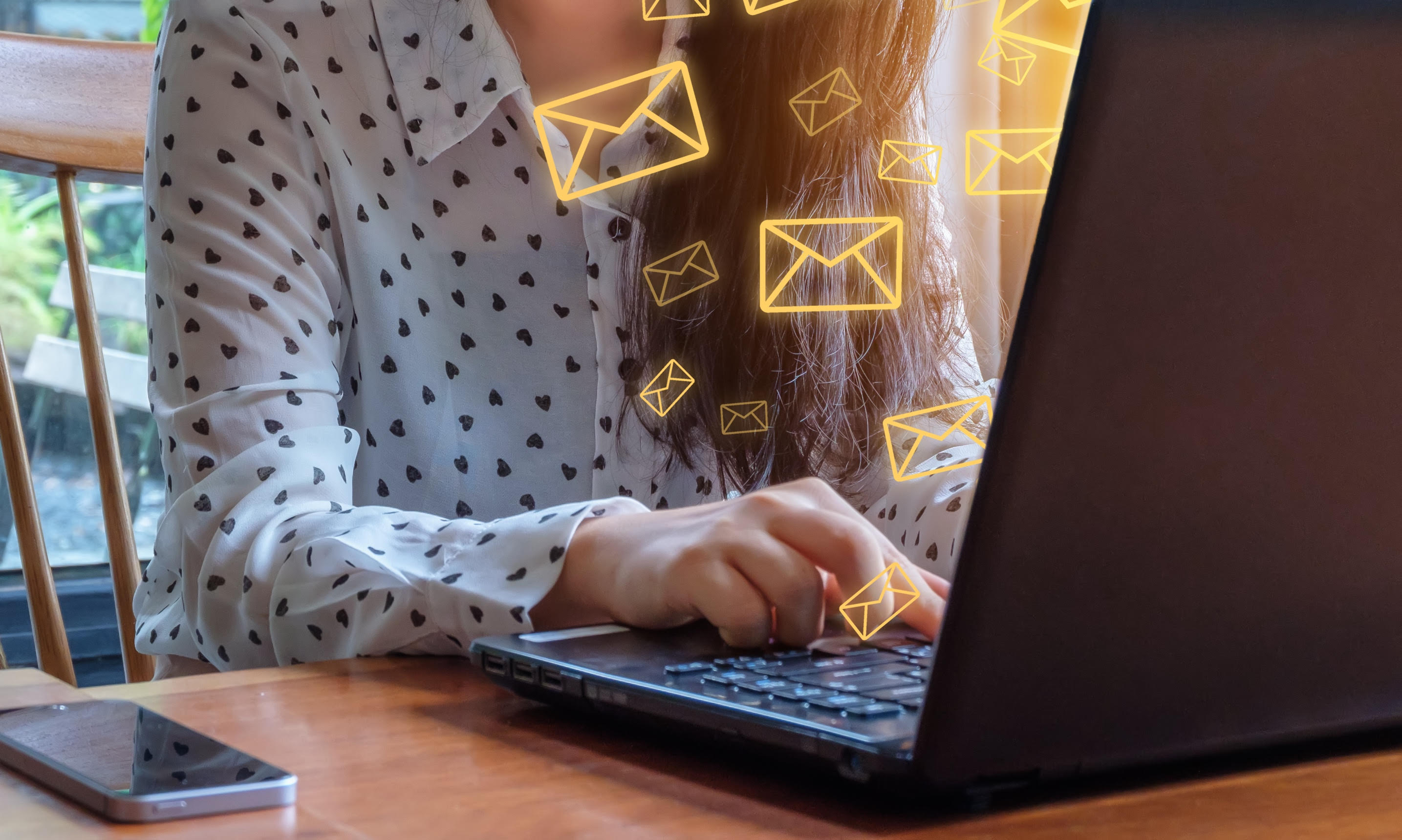 Woman typing on a laptop